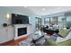 Cozy living room area with a fireplace and large windows, leading out to the deck at 2134 Landfall Way, Seabrook Island, SC 29455