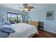 This bedroom has blue walls, wood floors, and sliding glass doors opening to a balcony at 2134 Landfall Way, Seabrook Island, SC 29455