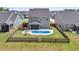 Aerial view showcases a fenced backyard with a pool and an outdoor patio at 214 Squire Pope Rd, Summerville, SC 29486