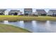 Landscaped backyard featuring a pond, wooden fence, and screened porch offers serene outdoor living at 214 Squire Pope Rd, Summerville, SC 29486