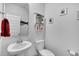 Neutral powder room with pedestal sink, toilet, and decorative artwork at 214 Squire Pope Rd, Summerville, SC 29486