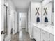 Bathroom features white cabinets, tile floors, and a mirror with decorative oars at 214 Squire Pope Rd, Summerville, SC 29486