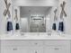 Nautical themed bathroom with double sink vanity and decorative oars on the walls at 214 Squire Pope Rd, Summerville, SC 29486