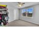 Bright bedroom with neutral walls, carpeted floor, ceiling fan, and natural light from two windows at 214 Squire Pope Rd, Summerville, SC 29486