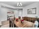 Bright dining room featuring a wooden table, stylish chandelier, and beach themed wall art at 214 Squire Pope Rd, Summerville, SC 29486