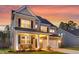 Charming two-story home with brick and siding, a covered front porch, and an attached garage at 214 Squire Pope Rd, Summerville, SC 29486