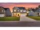 Charming two-story home with manicured lawn, brick accents, and attached two-car garage at 214 Squire Pope Rd, Summerville, SC 29486