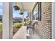 Inviting front porch with wicker chairs and hanging flower baskets at 214 Squire Pope Rd, Summerville, SC 29486