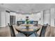 Open kitchen boasts stainless appliances, white cabinets, large island with seating, and a dining table at 214 Squire Pope Rd, Summerville, SC 29486