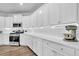 Bright kitchen features white cabinets, quartz countertops, subway tile backsplash, and stainless appliances at 214 Squire Pope Rd, Summerville, SC 29486