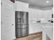 Stainless steel fridge and white cabinetry complement this modern kitchen space at 214 Squire Pope Rd, Summerville, SC 29486