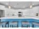 This kitchen island features white countertops, a blue base, stainless sink, and seating for four at 214 Squire Pope Rd, Summerville, SC 29486