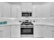 Well-lit kitchen featuring white cabinets, stainless steel appliances, and a white backsplash at 214 Squire Pope Rd, Summerville, SC 29486