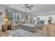 Spacious living room with plush seating, ceiling fan, and connecting view to kitchen with modern appliances at 214 Squire Pope Rd, Summerville, SC 29486