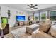 Comfortable living room featuring a large television, ceiling fan, and plush seating with ample natural light at 214 Squire Pope Rd, Summerville, SC 29486