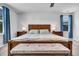 This is a spacious main bedroom featuring a queen bed, end tables, a ceiling fan, and natural light at 214 Squire Pope Rd, Summerville, SC 29486