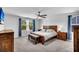 The main bedroom offers carpet floors, a ceiling fan, and natural light from two windows at 214 Squire Pope Rd, Summerville, SC 29486