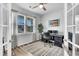 Bright home office featuring a ceiling fan, large window, neutral decor, and stylish furniture at 214 Squire Pope Rd, Summerville, SC 29486
