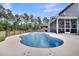 Inviting backyard with a sparkling pool, screened porch, and lush greenery at 214 Squire Pope Rd, Summerville, SC 29486