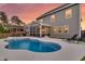 An outdoor pool with lounge chairs and a screened porch attached to a two-story house at 214 Squire Pope Rd, Summerville, SC 29486