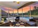 Cozy screened-in porch featuring comfortable seating, a ceiling fan, and a view of the backyard pool at 214 Squire Pope Rd, Summerville, SC 29486
