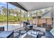 Comfortable screened-in porch with stylish furniture, offering a relaxing outdoor living space at 214 Squire Pope Rd, Summerville, SC 29486