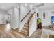 Staircase with carpeted steps and white wooden railing leading to the upper level at 214 Squire Pope Rd, Summerville, SC 29486