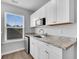Wet bar with white cabinets, undermount sink and granite countertops at 214 Squire Pope Rd, Summerville, SC 29486