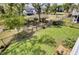 Well-maintained backyard with lush green grass, mature trees, and manicured garden beds at 2194 Cultura Cir, Mount Pleasant, SC 29466