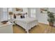 Cozy bedroom featuring a queen bed, shuttered windows, and a decorative plant, creating a peaceful atmosphere at 2194 Cultura Cir, Mount Pleasant, SC 29466