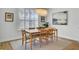 The dining room features a modern chandelier, a wooden table and seating for six at 2194 Cultura Cir, Mount Pleasant, SC 29466