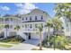 Charming two-story house elevated with a front porch and detailed stairs, surrounded by tropical greenery at 2194 Cultura Cir, Mount Pleasant, SC 29466