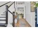 Elegant foyer features a staircase, hardwood floors, and stylish decor leading into a light-filled living space at 2194 Cultura Cir, Mount Pleasant, SC 29466