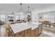 Bright, open kitchen with a large island, stainless steel appliances, and a view into the living and dining areas at 2194 Cultura Cir, Mount Pleasant, SC 29466