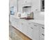 White cabinets with modern hardware, countertops, and tile backsplash, with stainless steel cooktop at 2194 Cultura Cir, Mount Pleasant, SC 29466