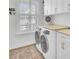 Laundry room boasts a washer and dryer, countertop, and storage cabinets at 2194 Cultura Cir, Mount Pleasant, SC 29466