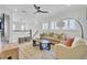 Bright living room featuring comfortable seating, a ceiling fan, and large windows with plantation shutters at 2194 Cultura Cir, Mount Pleasant, SC 29466