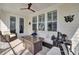 Inviting screened porch boasts outdoor seating and a cozy fire table for relaxing evenings at 2194 Cultura Cir, Mount Pleasant, SC 29466