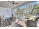 Relaxing screened porch features a ceiling fan and comfortable seating with a wooded view at 2194 Cultura Cir, Mount Pleasant, SC 29466