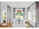 Bright dining area with modern pendant lighting, glass table, and backyard view at 224 Callibluff Dr, Summerville, SC 29486