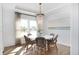 Cozy dining room with a beaded chandelier, bright windows, and chic decor at 224 Callibluff Dr, Summerville, SC 29486