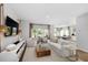 Bright, open living room with white sofas, modern decor, and an inviting view of the outdoors at 224 Callibluff Dr, Summerville, SC 29486
