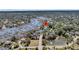 Beautiful aerial view of waterfront property with docks, lush landscaping, and surrounding neighborhood at 2254 Beckenham Dr, Mount Pleasant, SC 29466