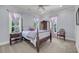 The bedroom features pale blue walls, plush carpet, a ceiling fan, and natural light from the bright windows at 2254 Beckenham Dr, Mount Pleasant, SC 29466