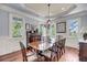Bright dining room features a chandelier, windows, and a large wood table with seating for eight at 2254 Beckenham Dr, Mount Pleasant, SC 29466