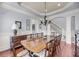 Bright dining room features a chandelier, windows, and a large wood table with seating for ten at 2254 Beckenham Dr, Mount Pleasant, SC 29466
