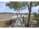 Scenic view of a wooden dock leading to waterfront homes in a serene marsh setting with a blue sky backdrop at 2254 Beckenham Dr, Mount Pleasant, SC 29466