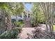 Lush landscaping surrounds the steps up to the beautiful porch and front entrance of this home at 2254 Beckenham Dr, Mount Pleasant, SC 29466