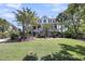 Beautiful two-story house with a manicured lawn, mature trees, and a welcoming front porch at 2254 Beckenham Dr, Mount Pleasant, SC 29466