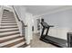 Hallway with staircase, wainscoting, and a view of a pantry and fitness equipment at 2254 Beckenham Dr, Mount Pleasant, SC 29466